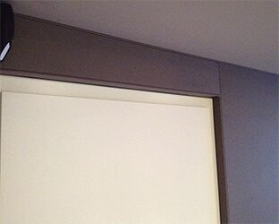 Visible edge covered with acoustic fabric on a door in the home cinema