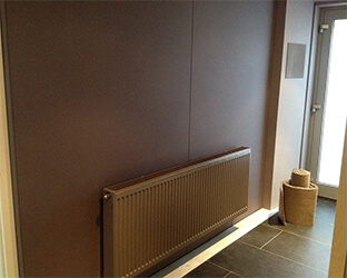 Rear wall in home cinema covered with acoustic fabric