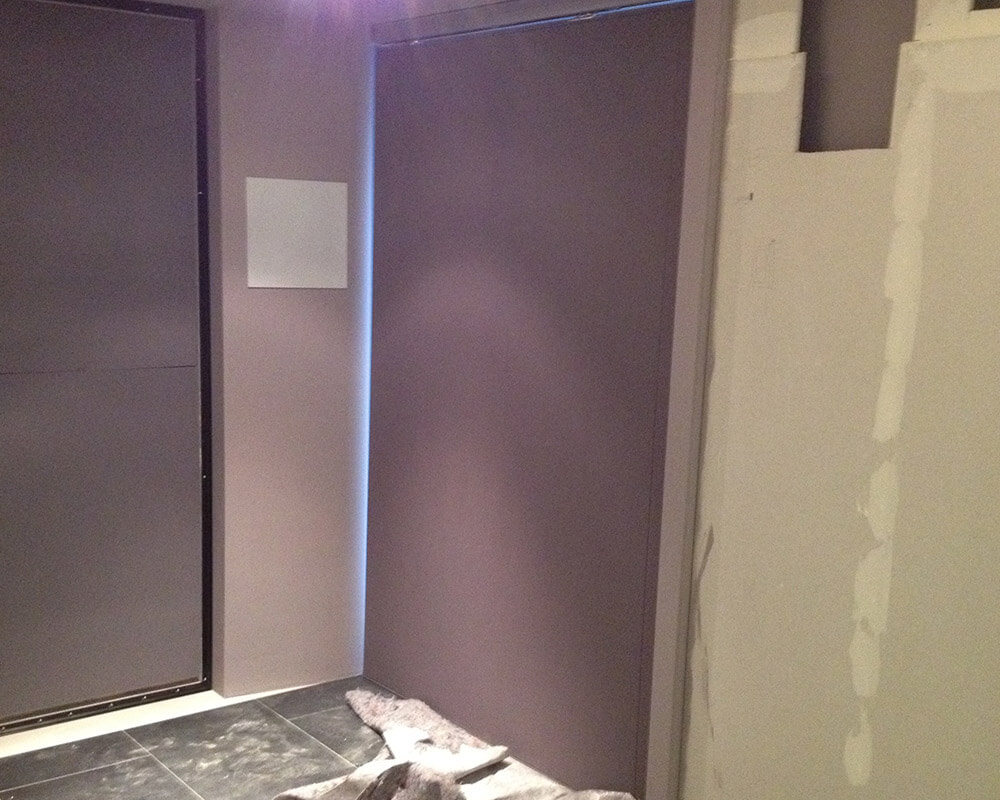 The sliding door in the home cinema covered with acoustic fabric